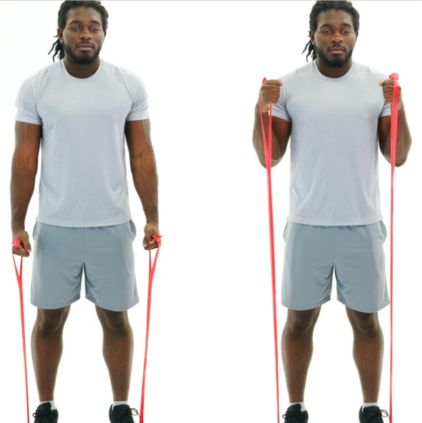 A man is standing and performing a biceps curl. The resistance is coming from the ground, therefore he biceps are being worked.