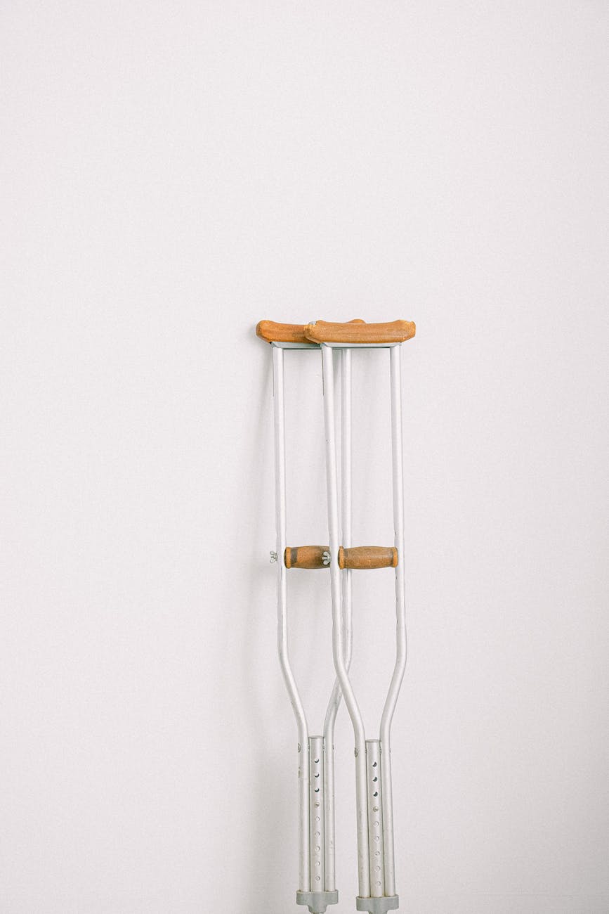 crutches against light white wall