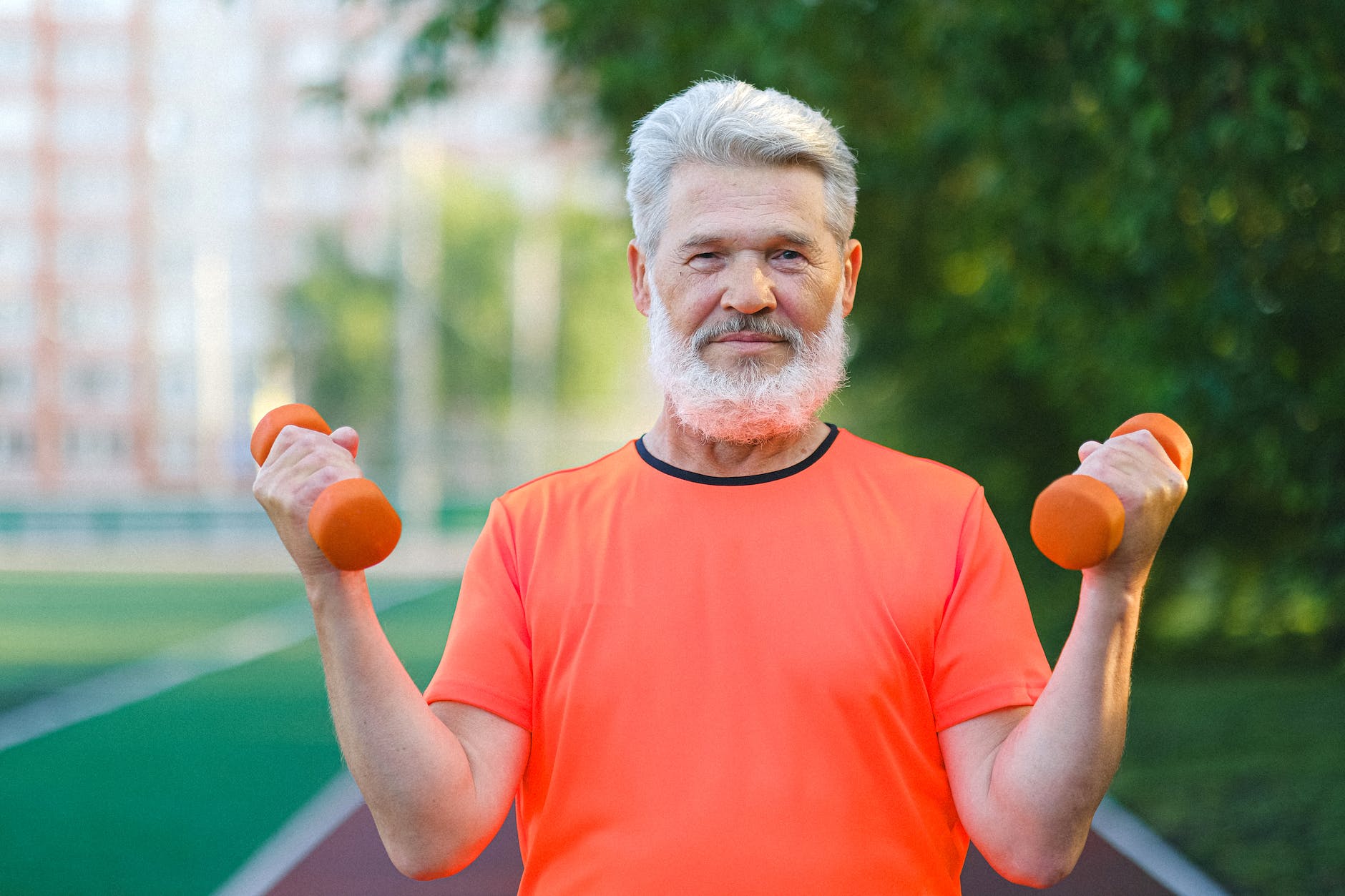 Older man lifting light weights. Strength training is a critical component of overall health and fitness
